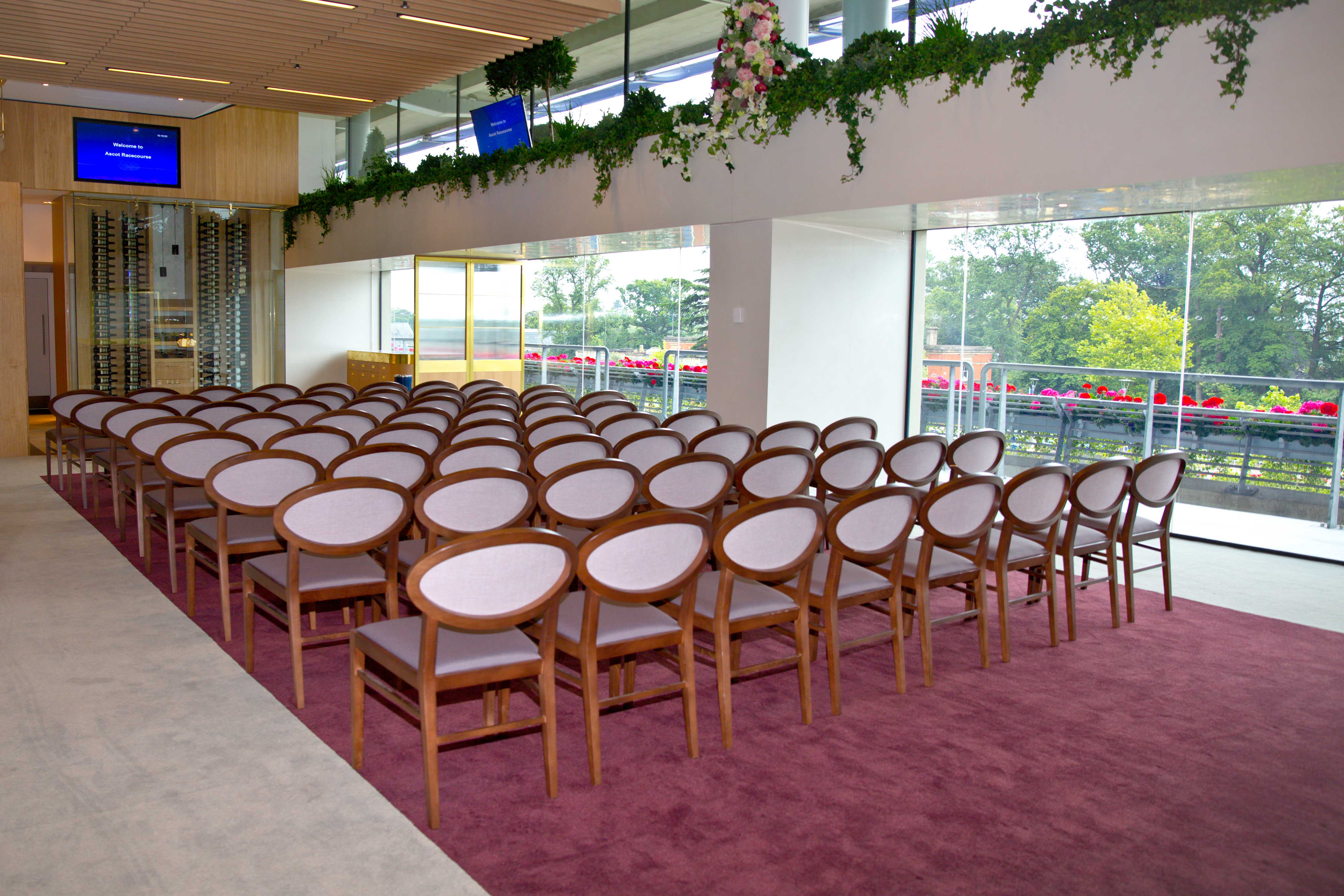Parade Ring Suite at Ascot Racecourse with elegant seating for events and natural light.