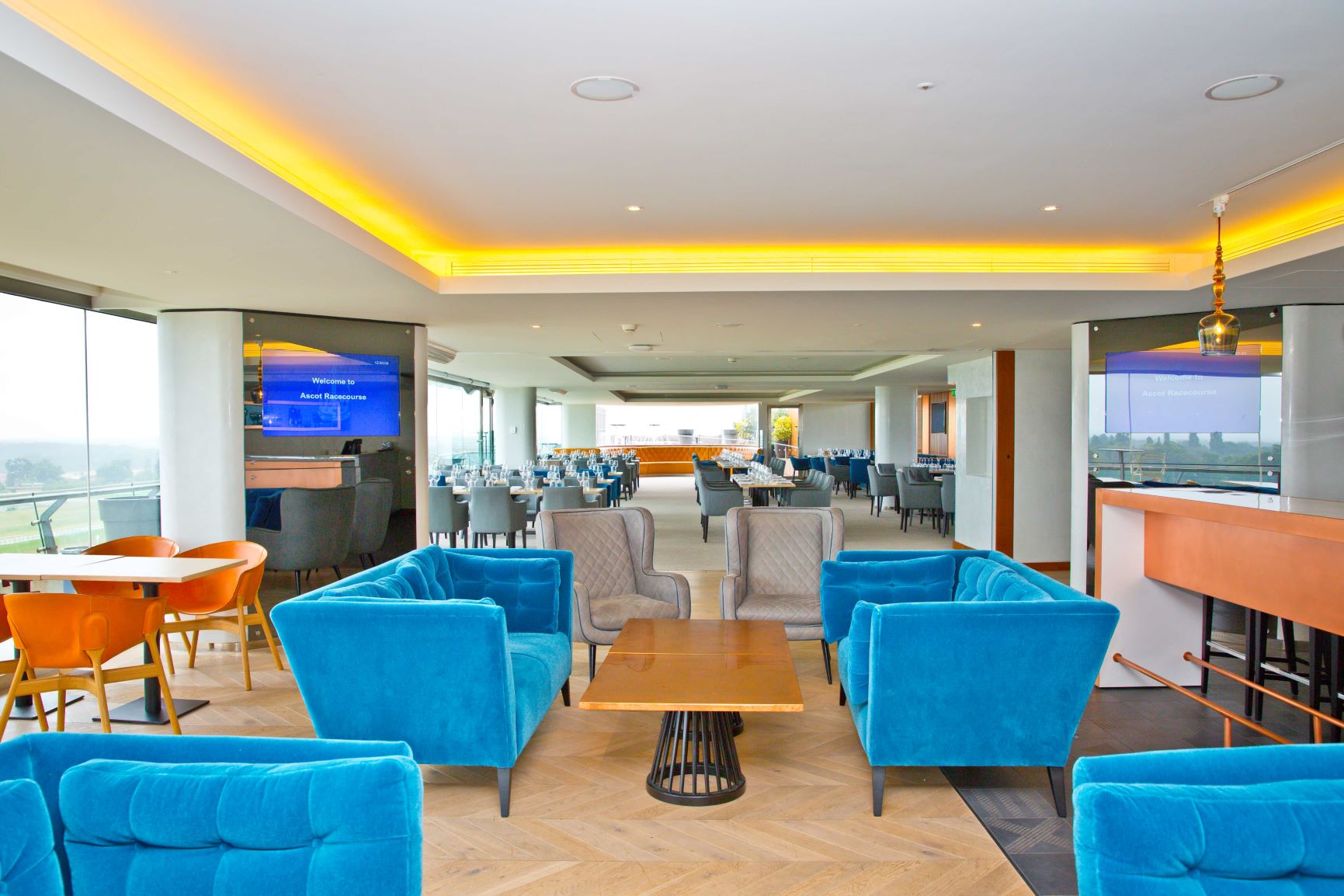 Modern event space at Ascot Racecourse with blue seating, ideal for corporate gatherings.