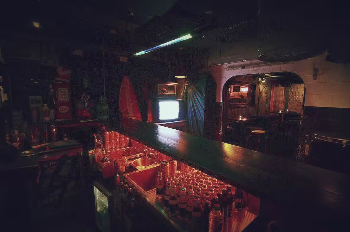 Intimate bar setting at The BSMT, warm lighting for networking events and gatherings.