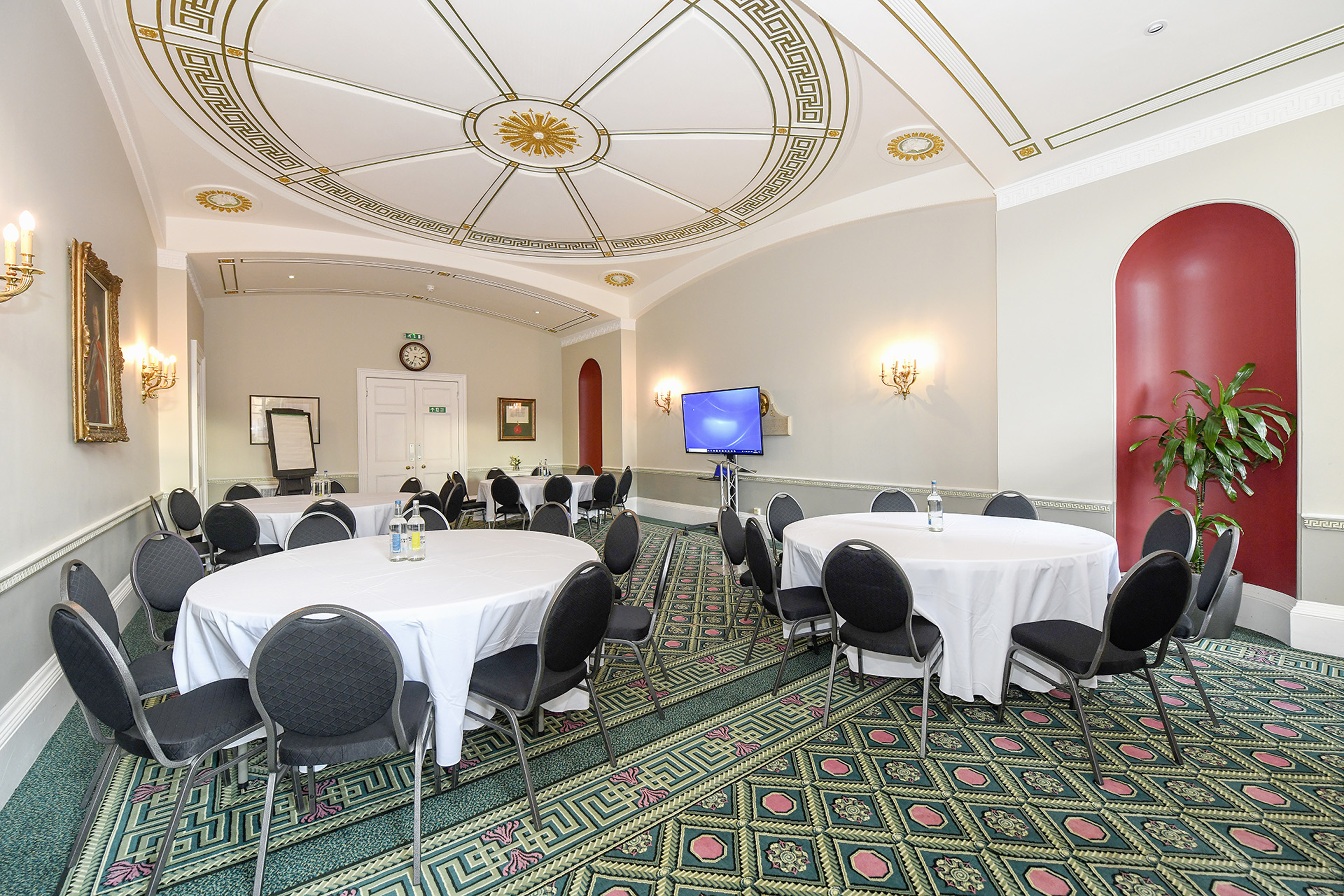Council Room in SCI Belgravia, elegant meeting space with round tables for events.