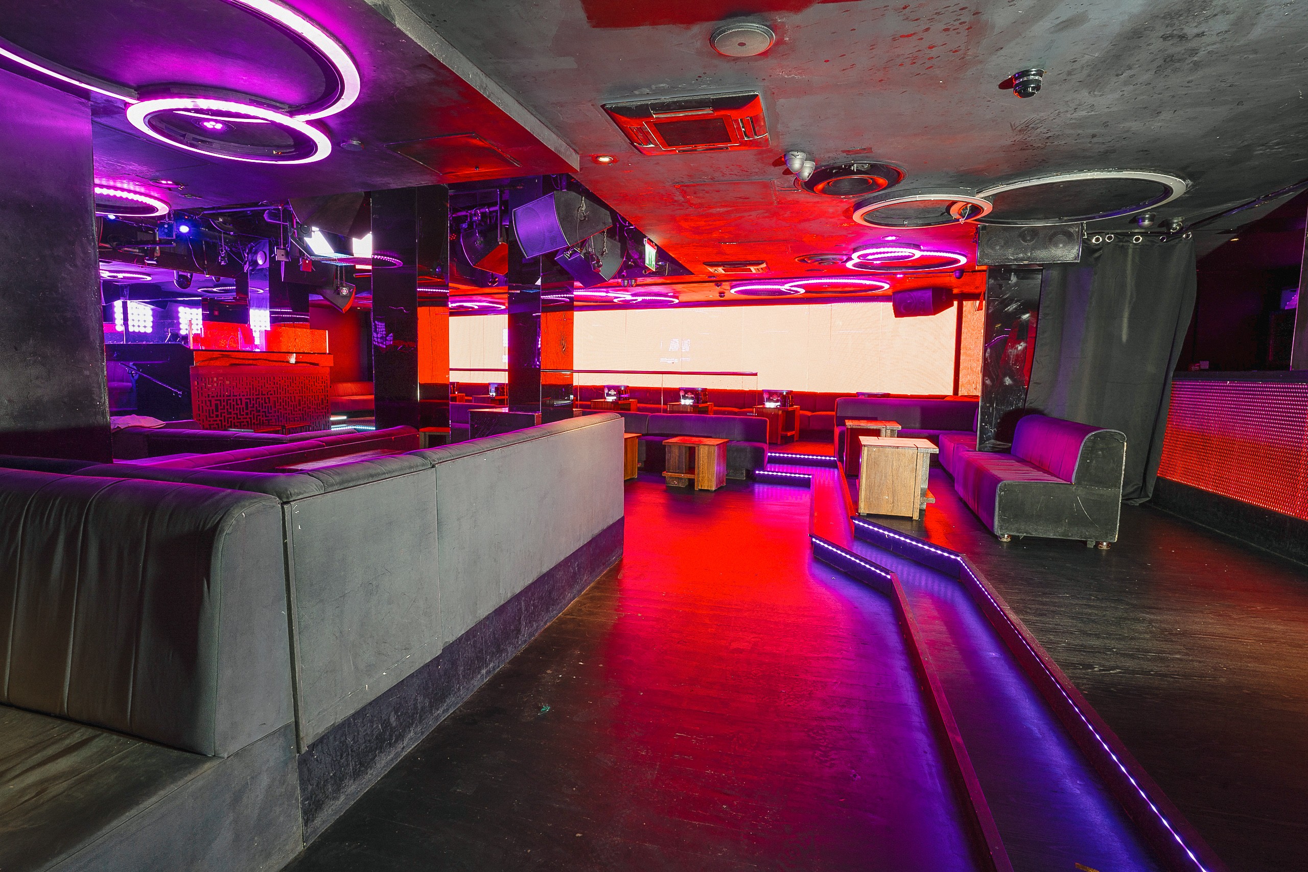 Modern event space with neon lighting for versatile gatherings and presentations.