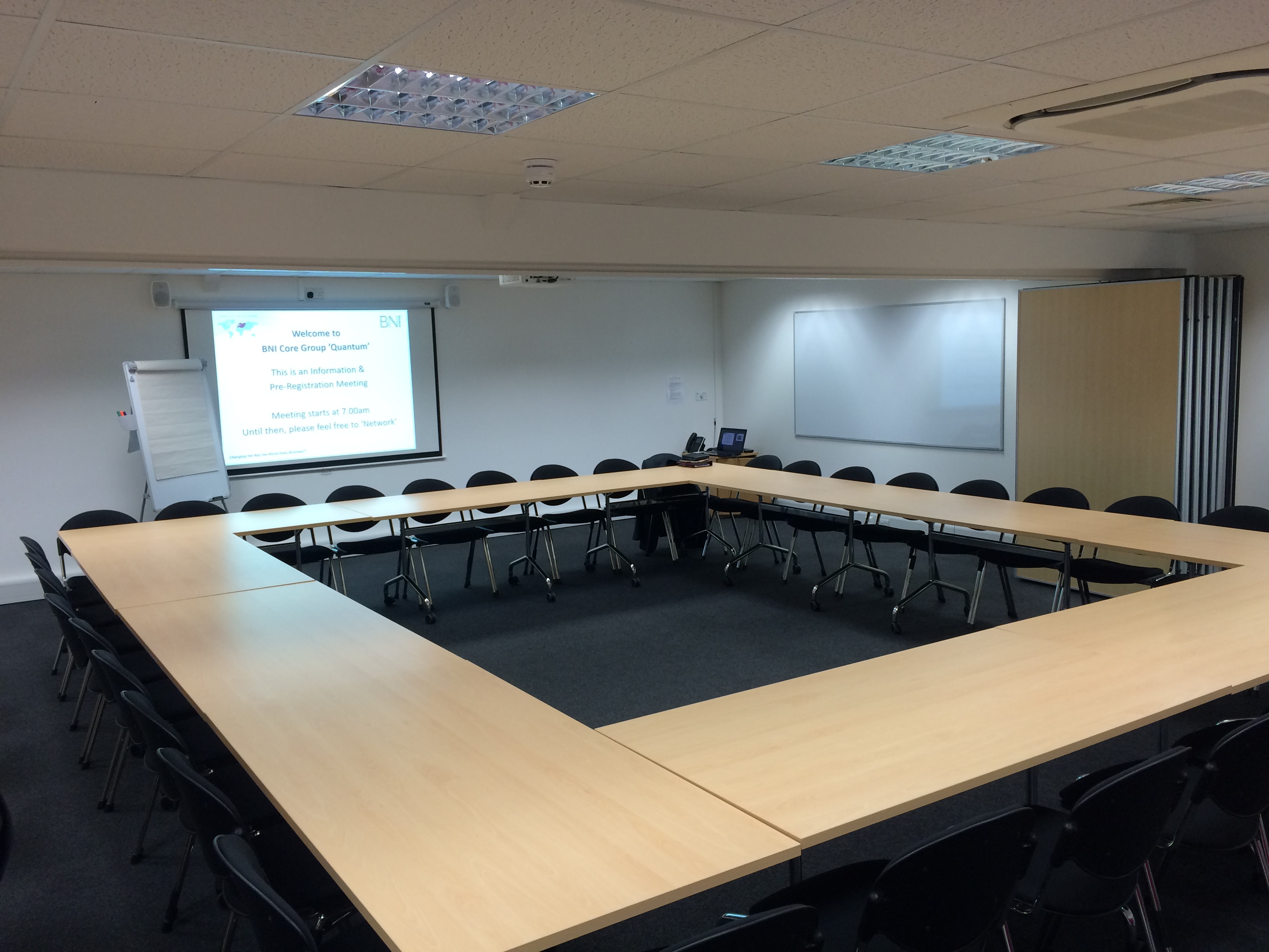 Conference Room in Pinnacle House, U-shape setup for collaborative meetings and presentations.