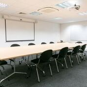 Meeting Room 1 in Pinnacle House with ergonomic chairs, ideal for workshops and presentations.