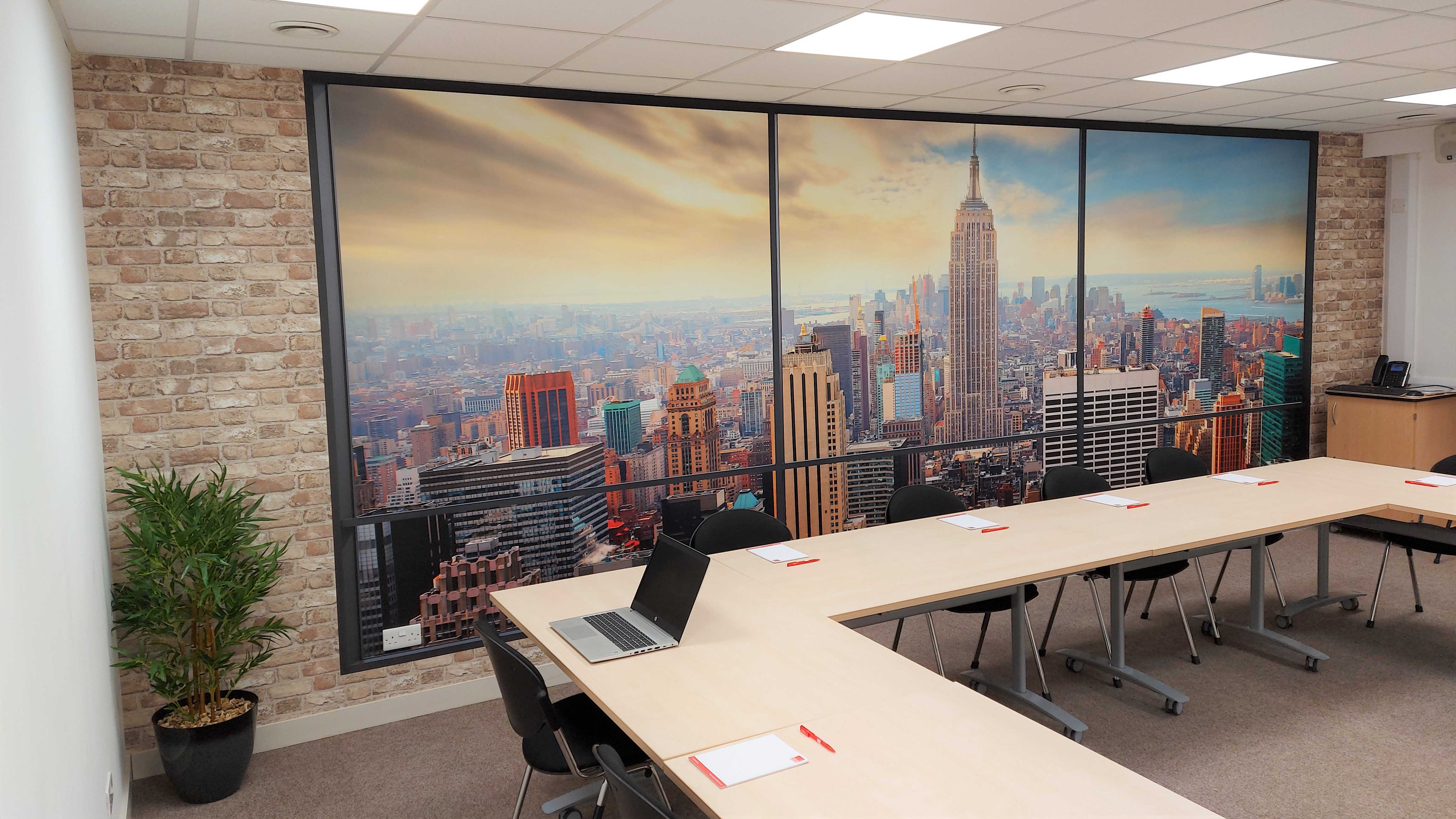 Modern conference room with skyline view, ideal for meetings and presentations.