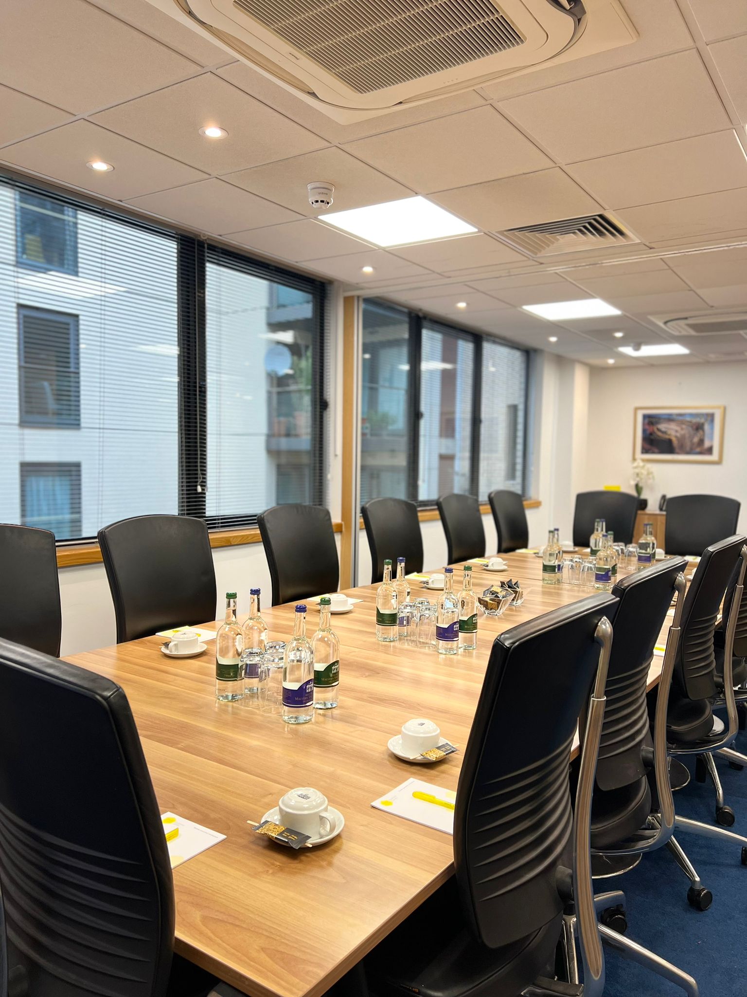 Dali Suite meeting room with wooden table, ideal for corporate events and workshops.