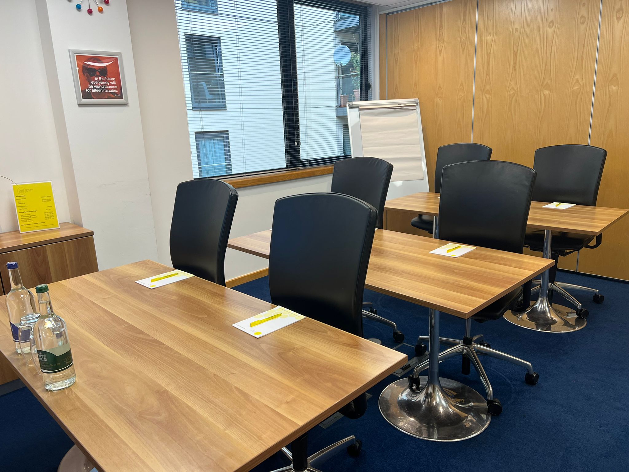 "Warhol in Regal Court meeting room with modern tables for collaborative sessions"