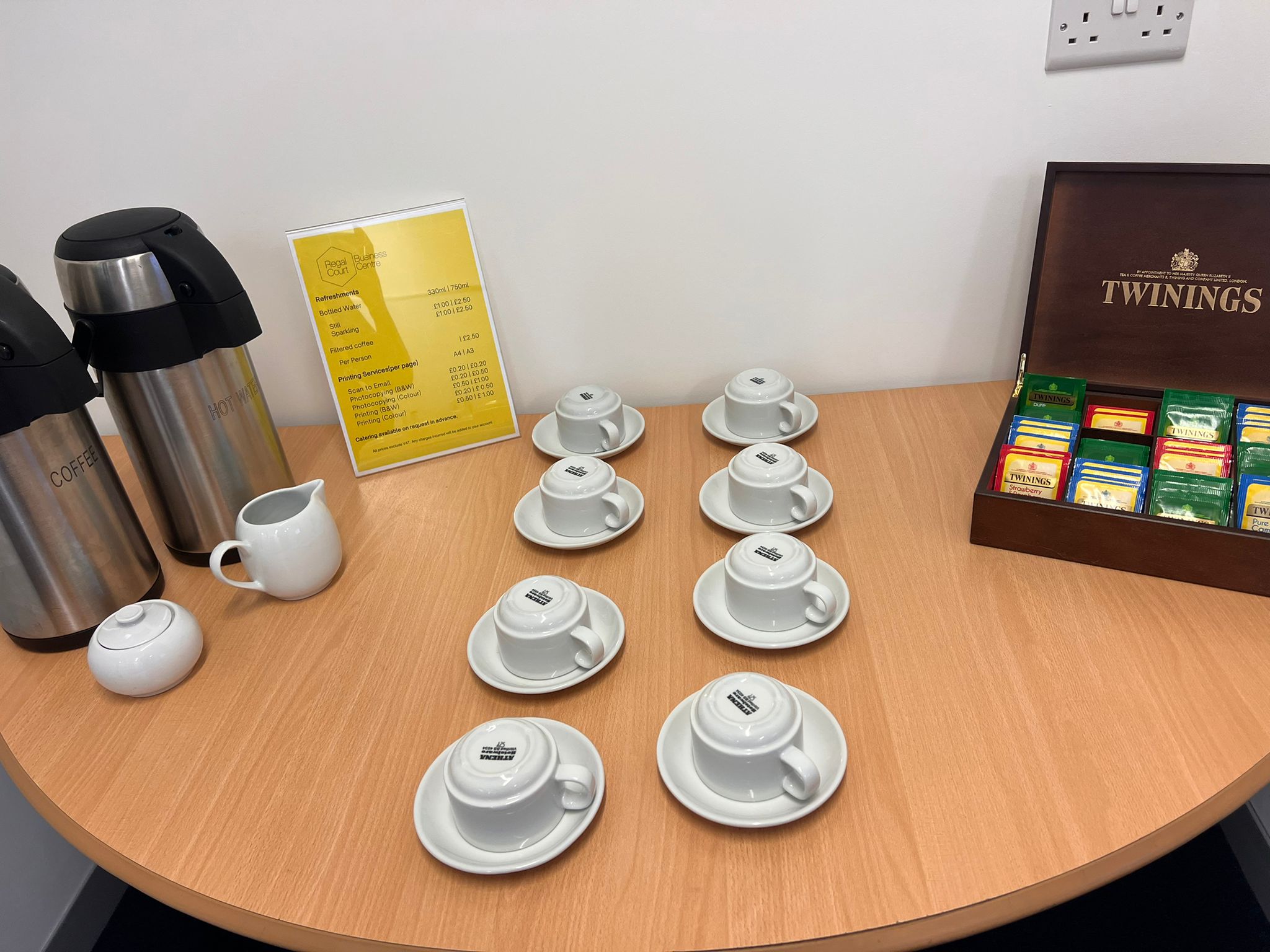 Refreshment station with coffee, tea, and elegant setup for meetings or events.