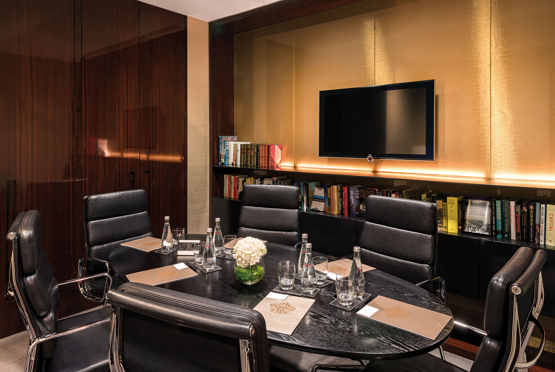 Private office meeting room at Bulgari Hotel London with sleek round table and leather chairs.