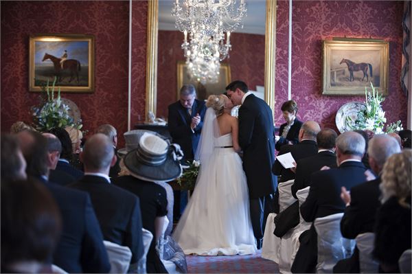 Elegant wedding ceremony at Exclusive Hire, Weston Park with classic chandelier and floral decor.