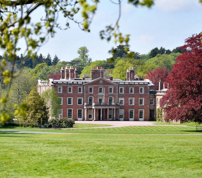 Historic mansion in lush greenery, ideal for upscale events and corporate retreats.