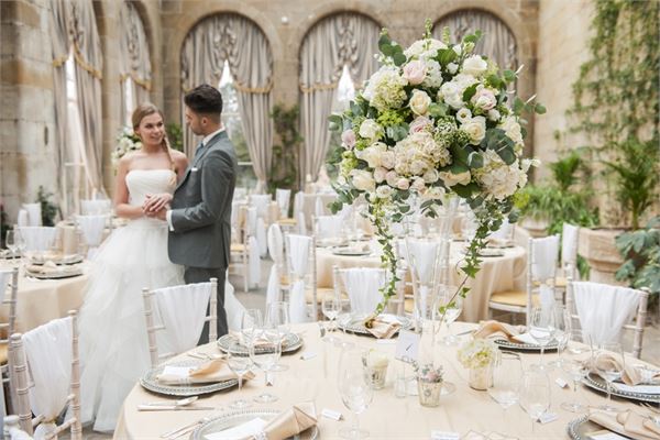 Victorian Orangery wedding reception with elegant floral centerpieces and romantic ambiance.