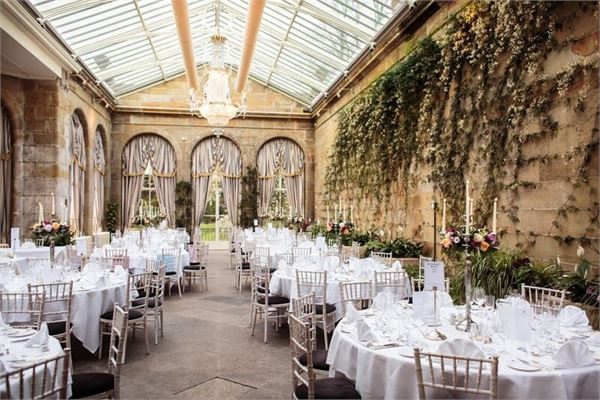 Victorian Orangery in Weston Park, elegant wedding venue with glass ceiling and lush decor.