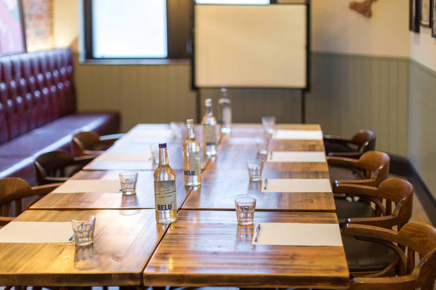 Venice Room meeting space with wooden table, ideal for collaborative events.