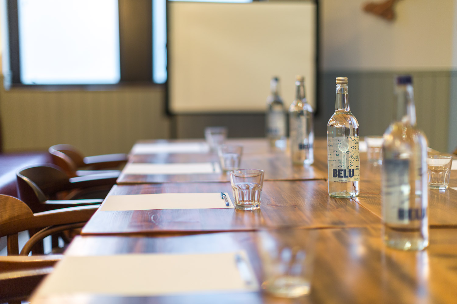 Polished wooden meeting table in The Venice Room, ideal for workshops and corporate events.