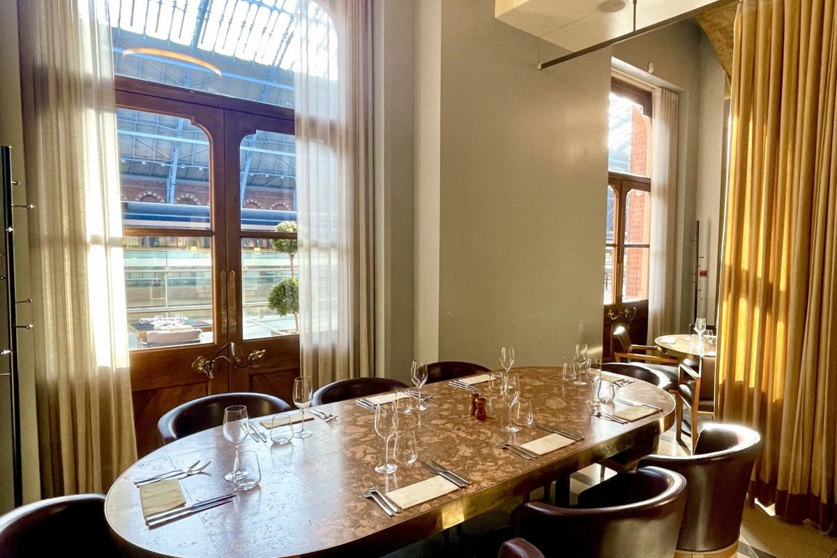 Stylish meeting space with oval table at St Pancras Brasserie for corporate events.