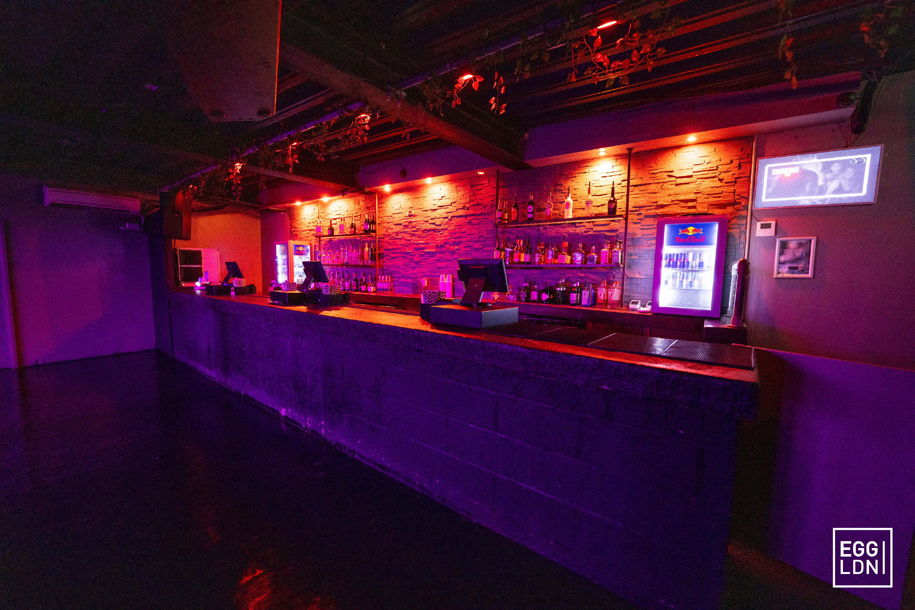 Stylish bar with purple lighting at Egg LDN, perfect for events and celebrations.
