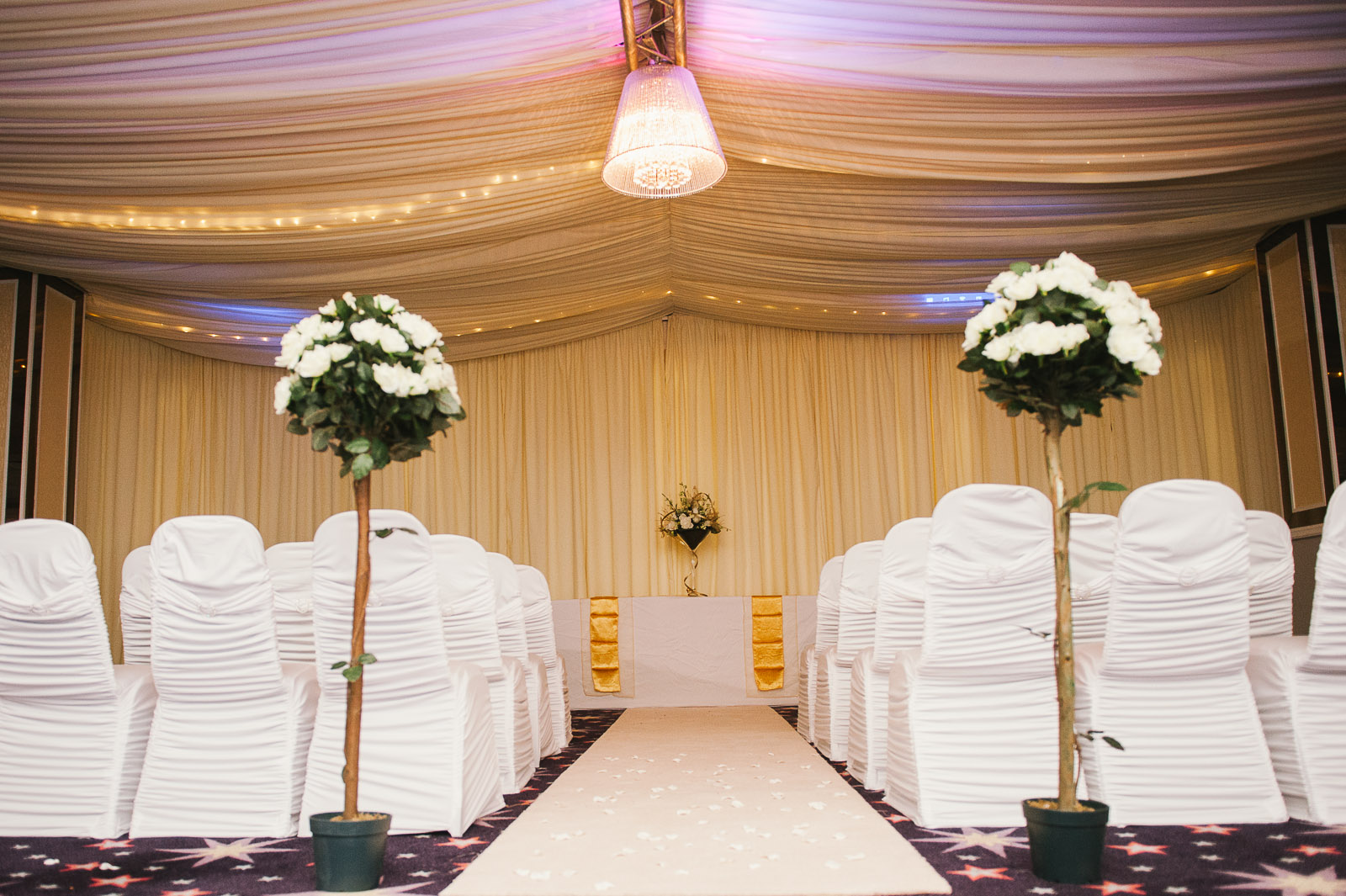Elegant wedding venue with draped decor and floral arrangements in Viva Blackpool.