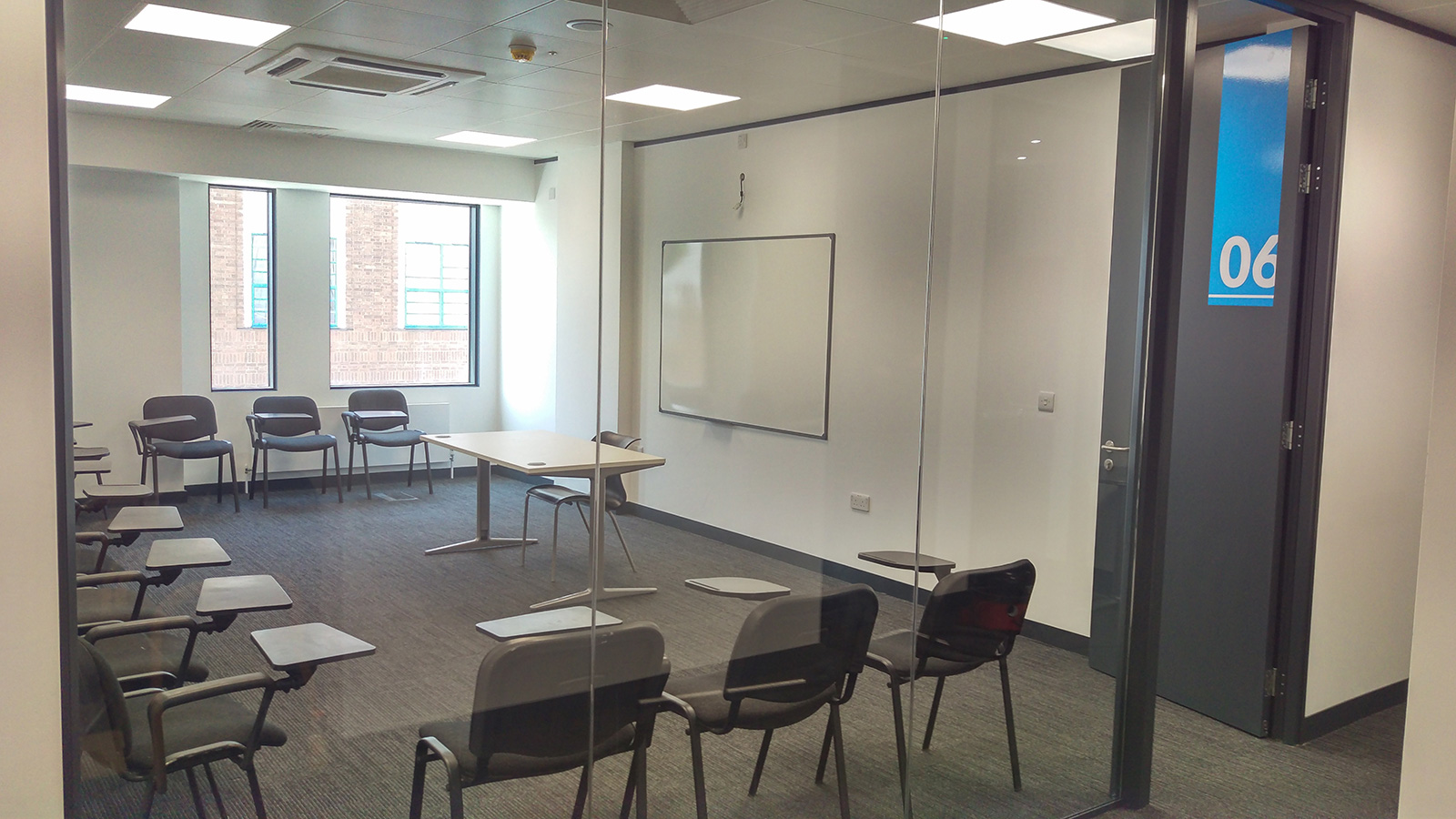 Modern meeting room with glass wall for workshops at Twin English Centre Greenwich.