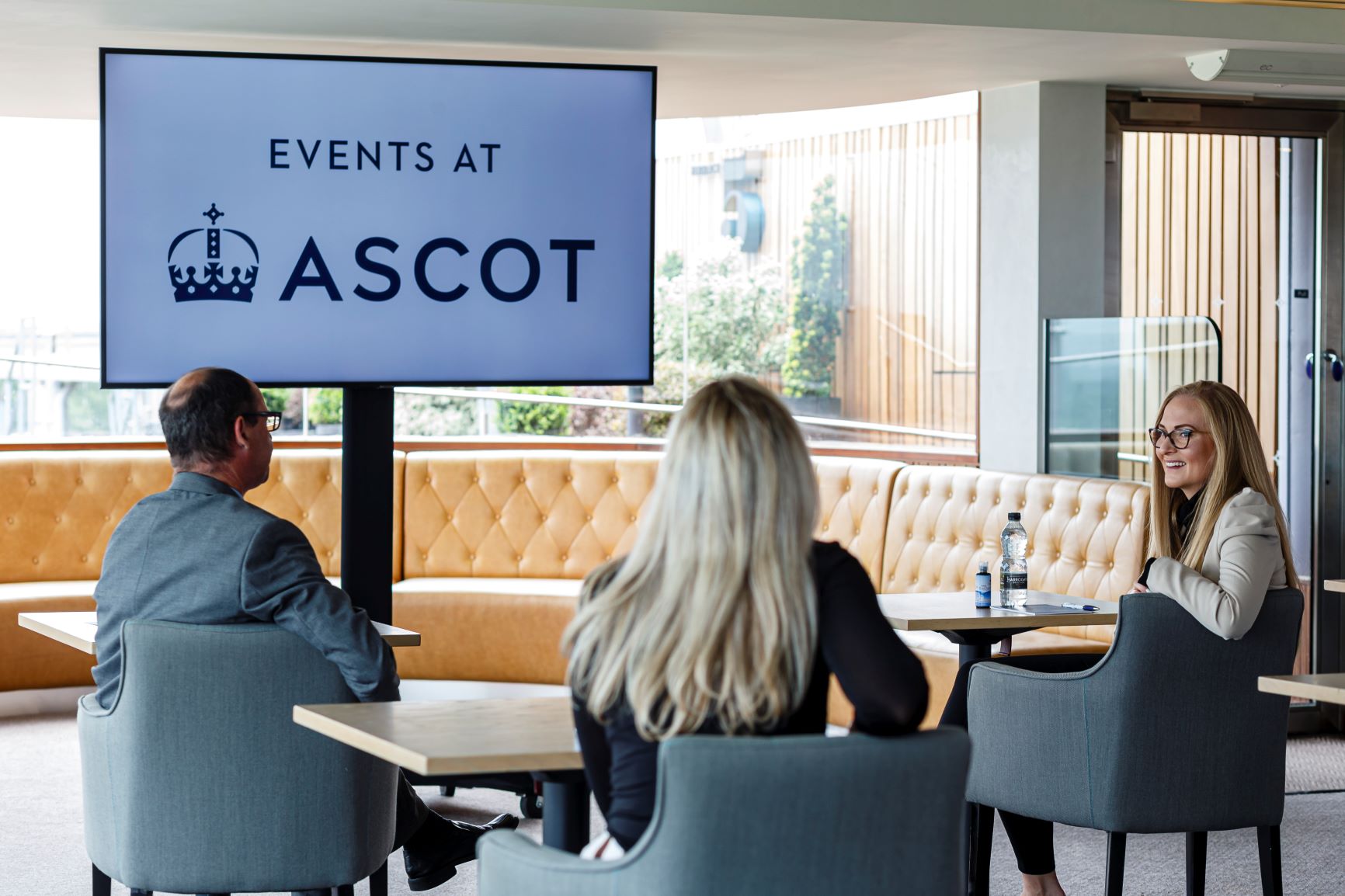 Professional meeting in Ascot Racecourse's On 5 Suite with modern decor.