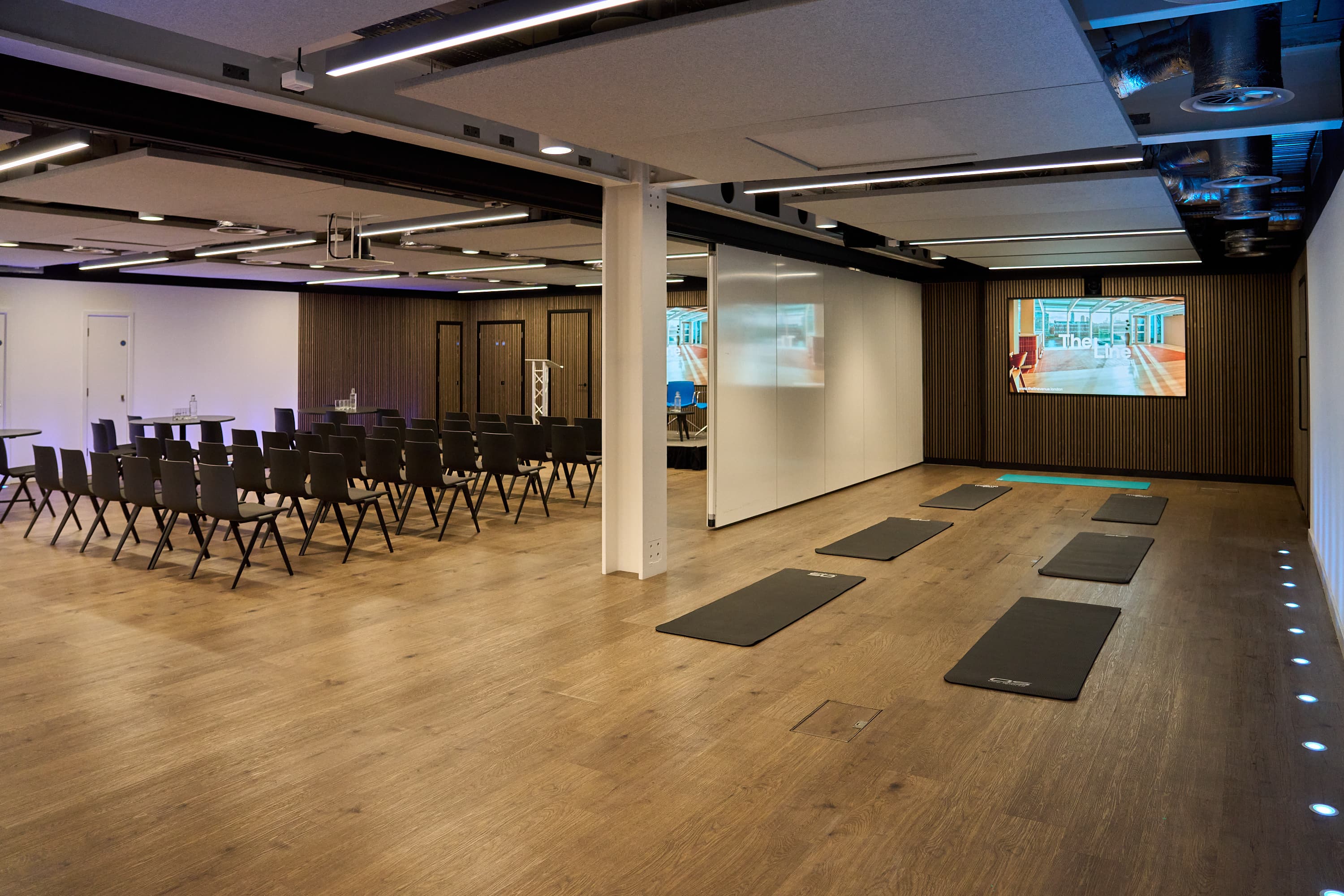 Waterline event space with theater seating and wellness zone for corporate meetings and retreats.