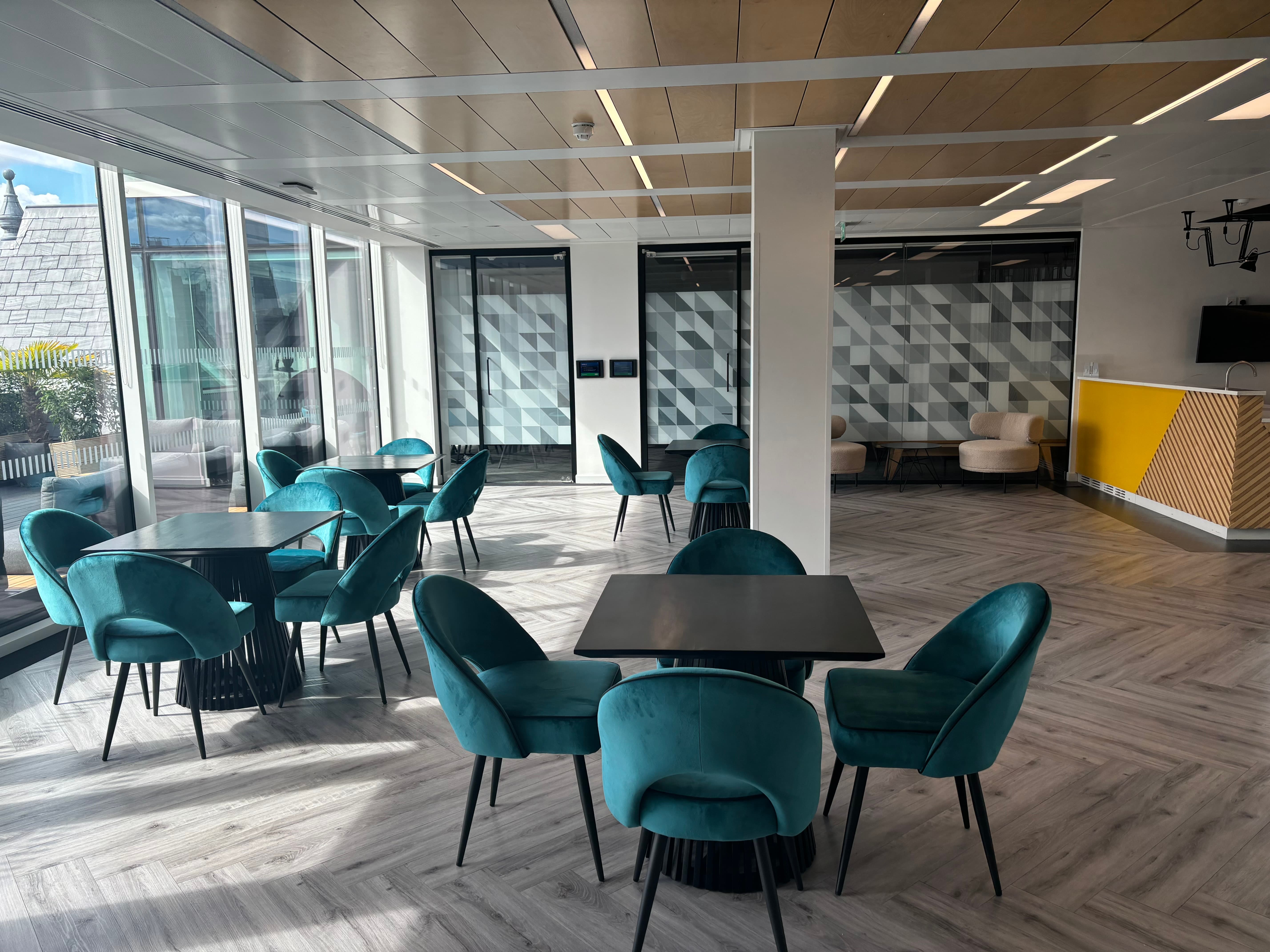 Modern coworking space with velvet seating for networking and small group events.