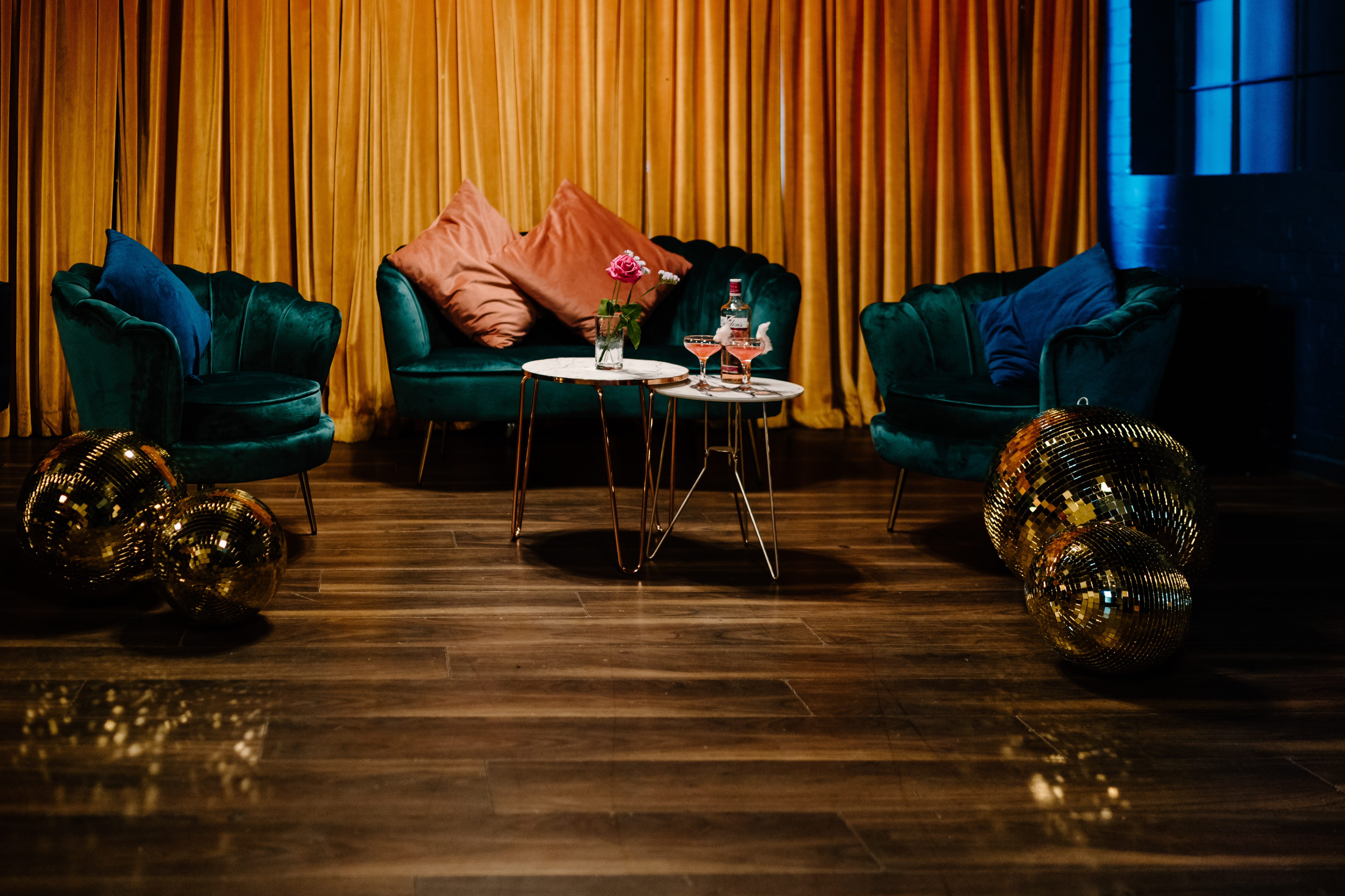 Stylish lounge setup with plush green chairs for intimate gatherings and networking events.