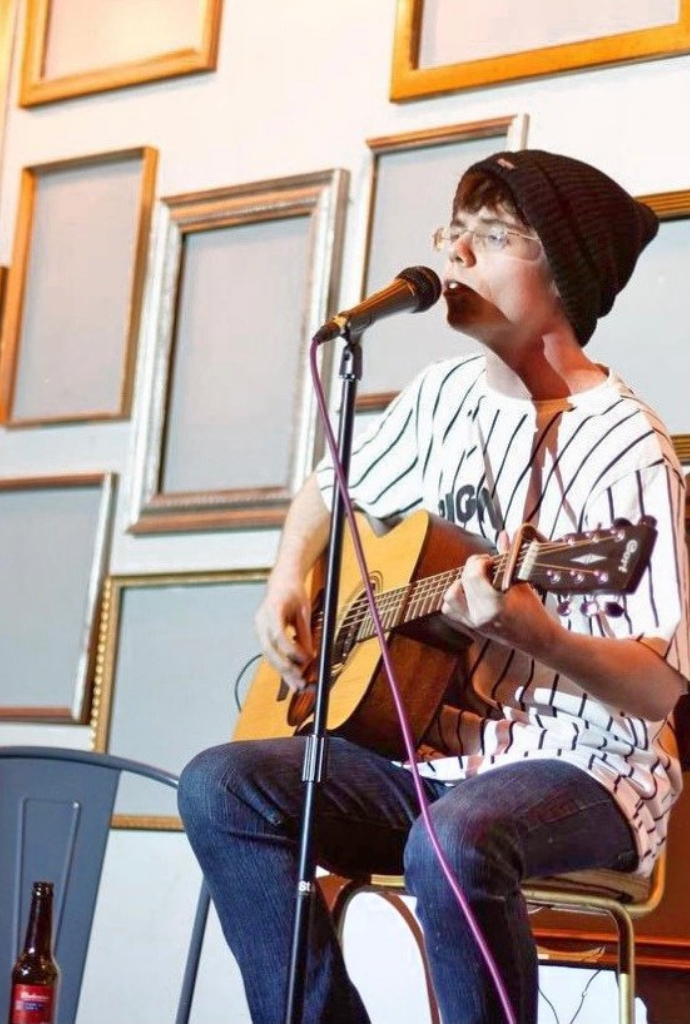 Performer engaging audience in intimate venue, perfect for open mic nights and small gatherings.