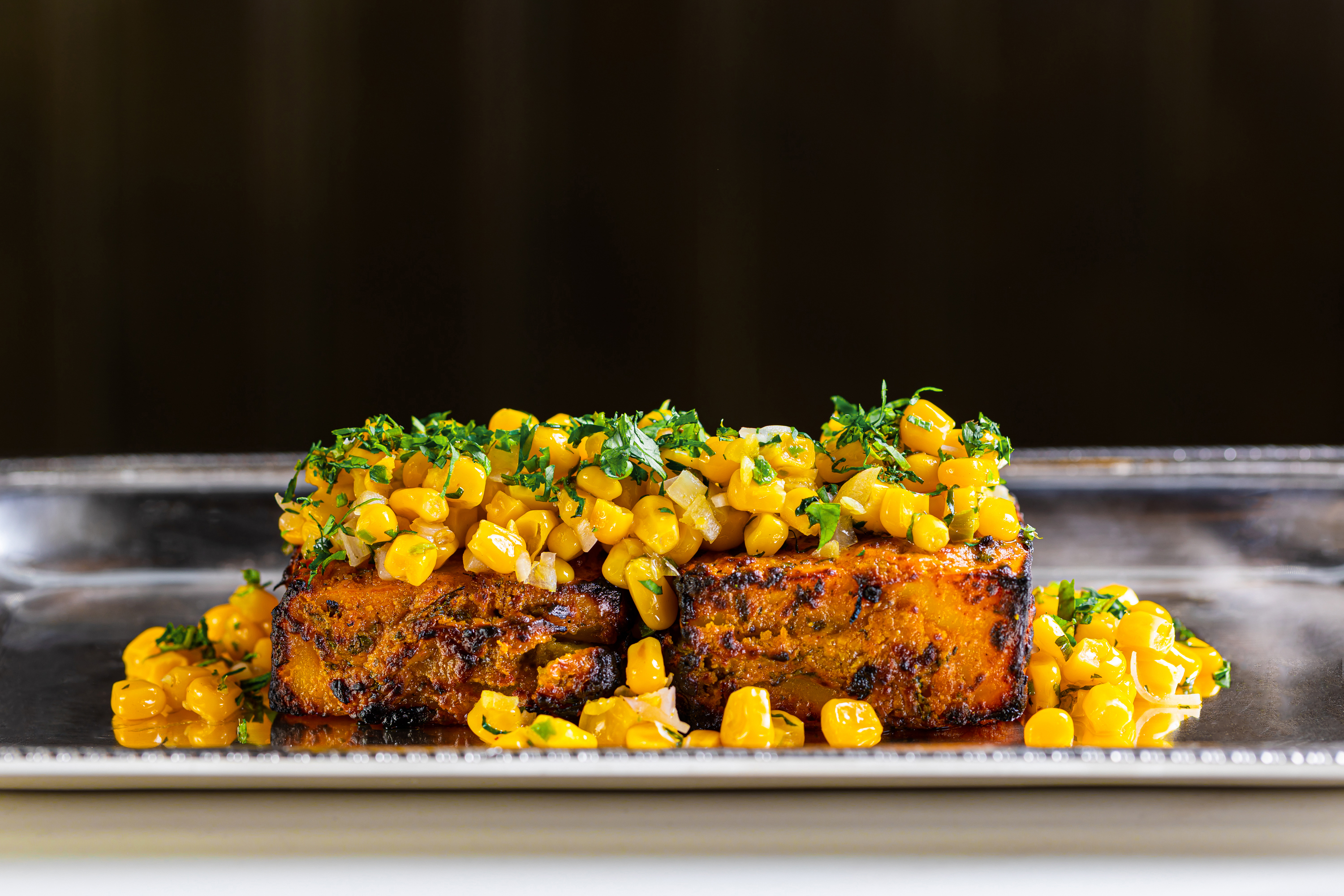 Private Dining Vault dish with grilled protein and corn salsa for upscale events.