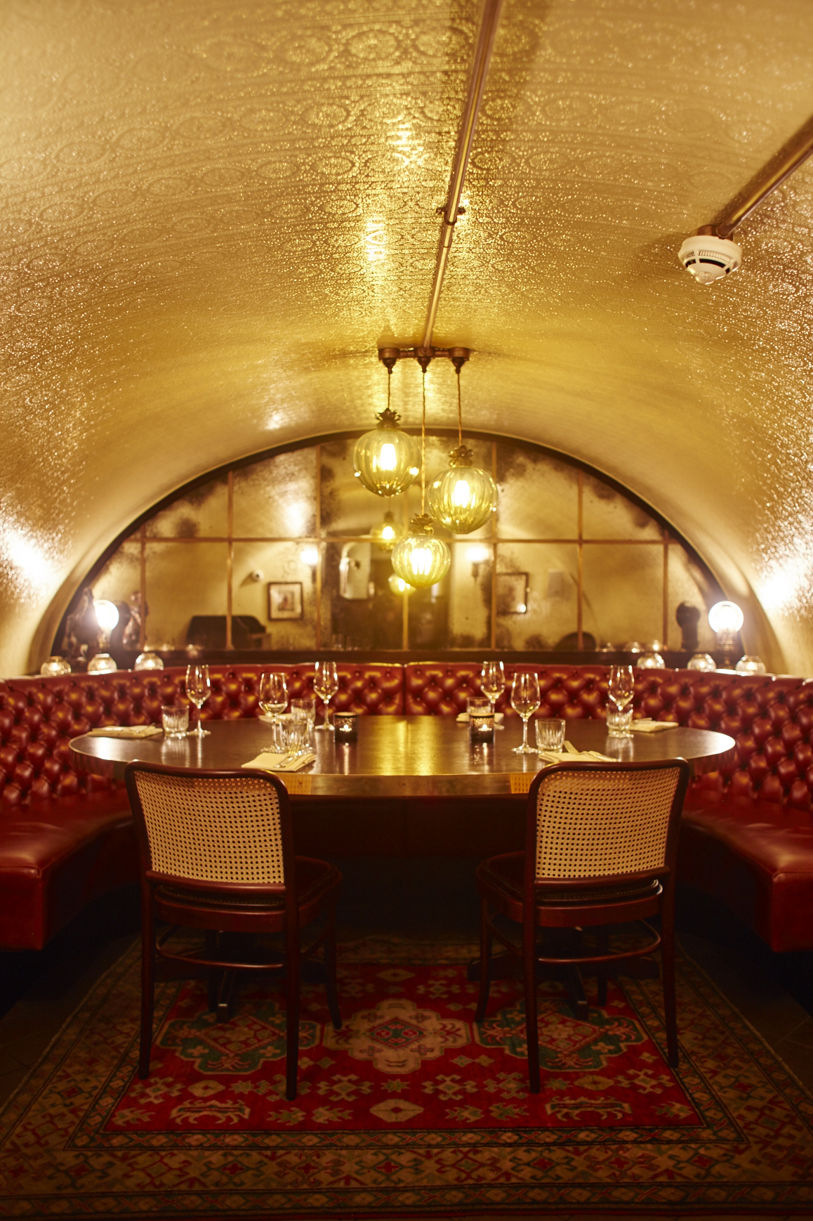Elegant private dining room with plush red seating, ideal for exclusive events and corporate meetings.