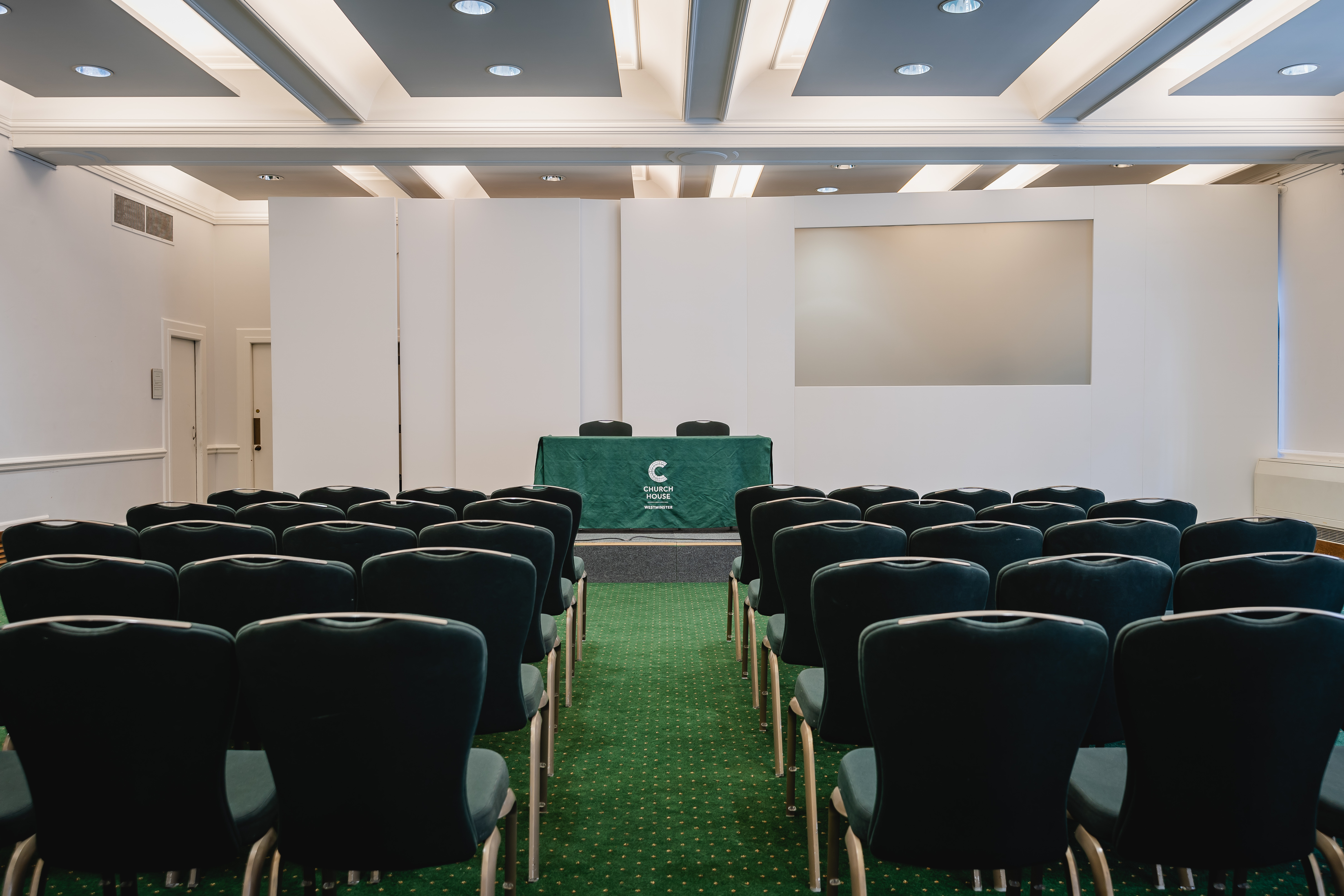 Harvey Goodwin Suite meeting room with green carpet, ideal for corporate events and workshops.