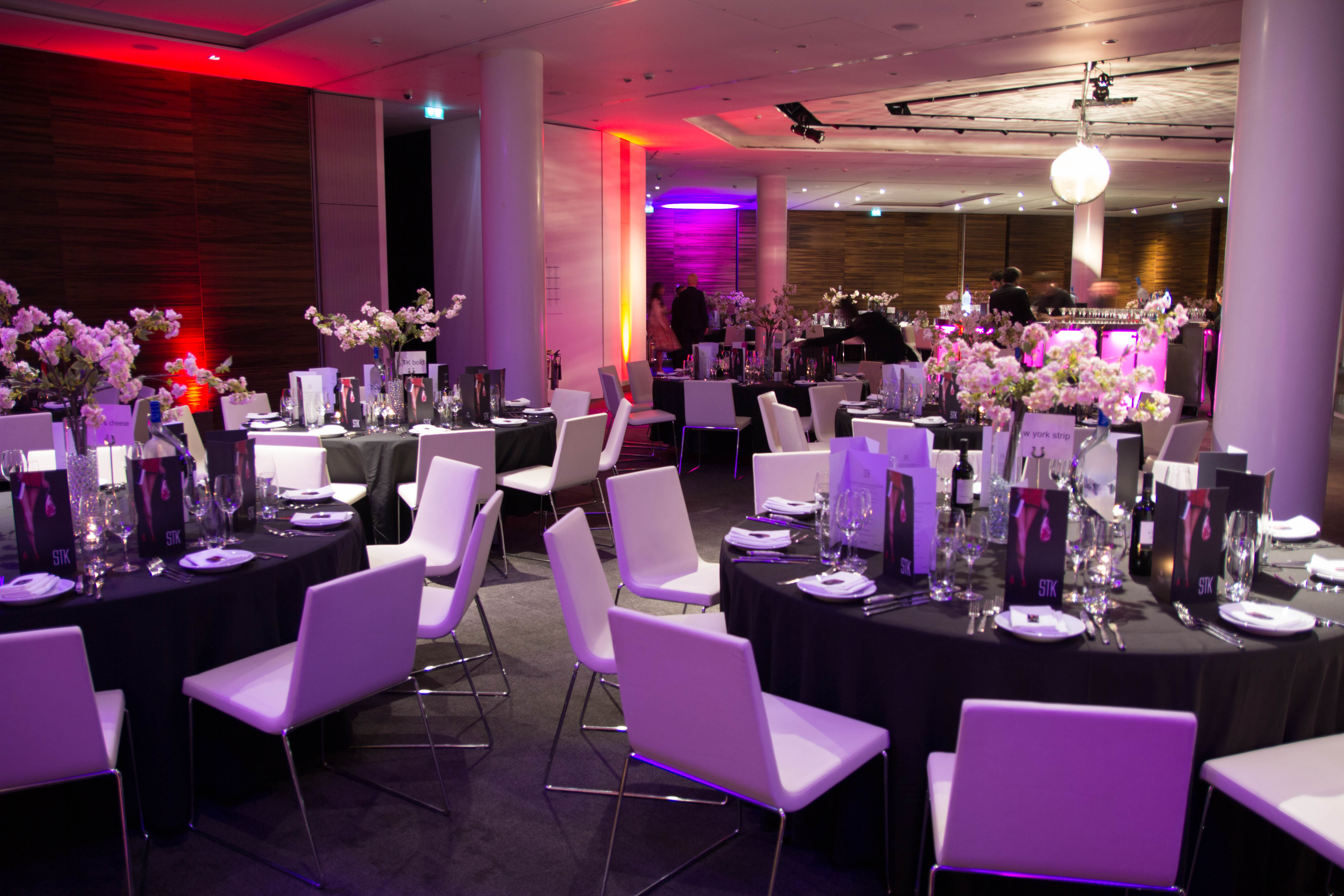 Elegant event space in ME London with floral centerpieces for formal gatherings.