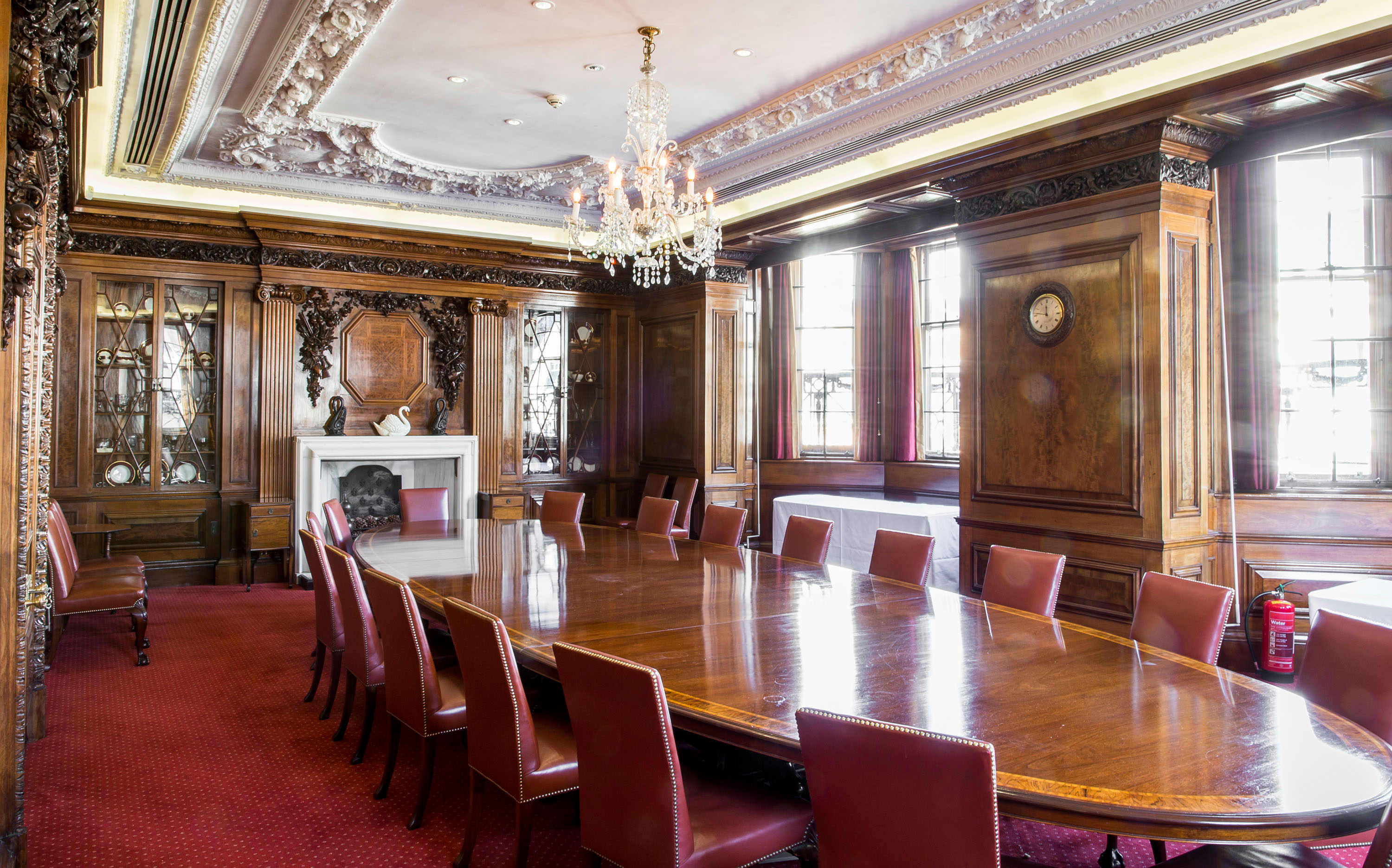 Elegant boardroom with wooden table and leather chairs, perfect for meetings and events.
