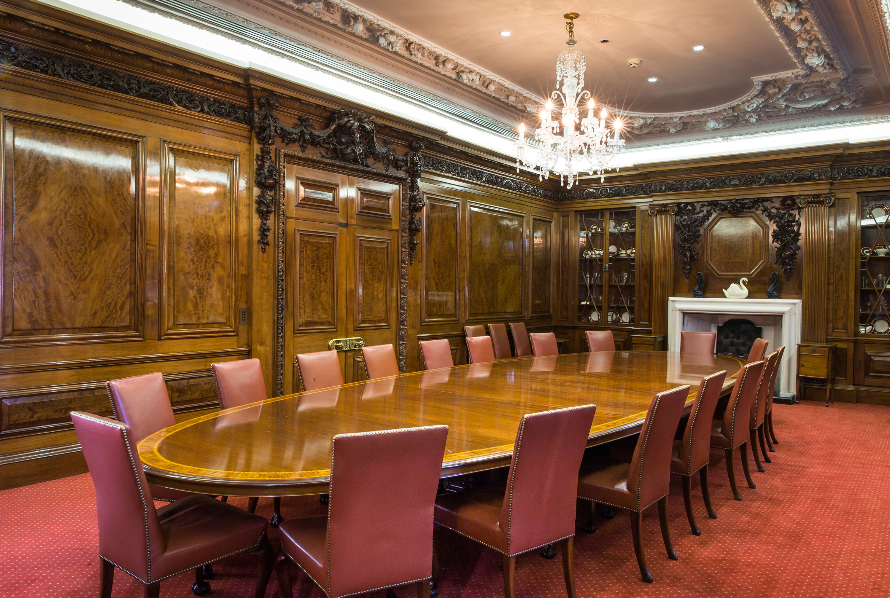Elegant boardroom with wooden paneling, ideal for executive meetings and presentations.