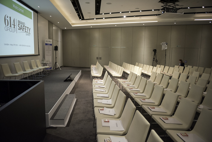 Modern conference setup in ME London Event Space with white chairs and presentation tech.