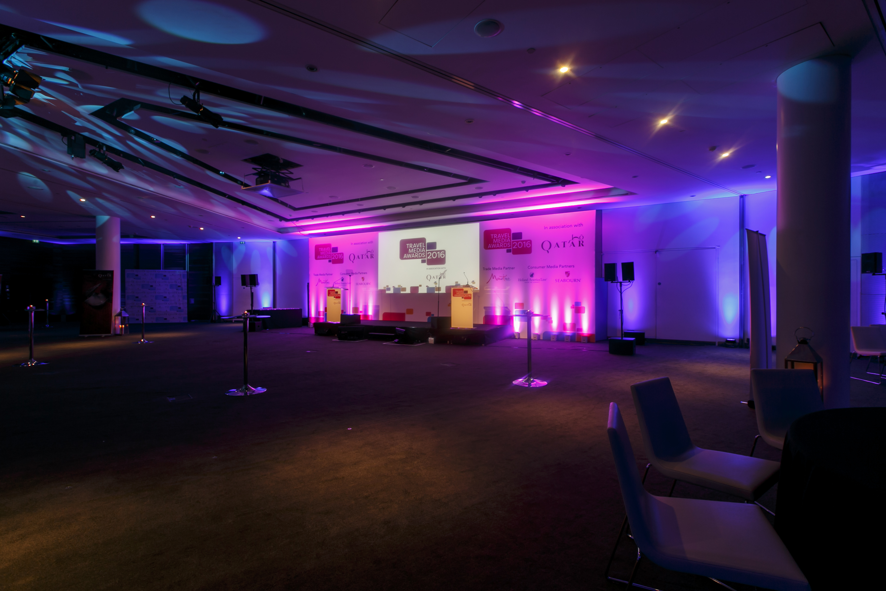 ME Room in ME London, well-lit conference space with central stage and large screen.