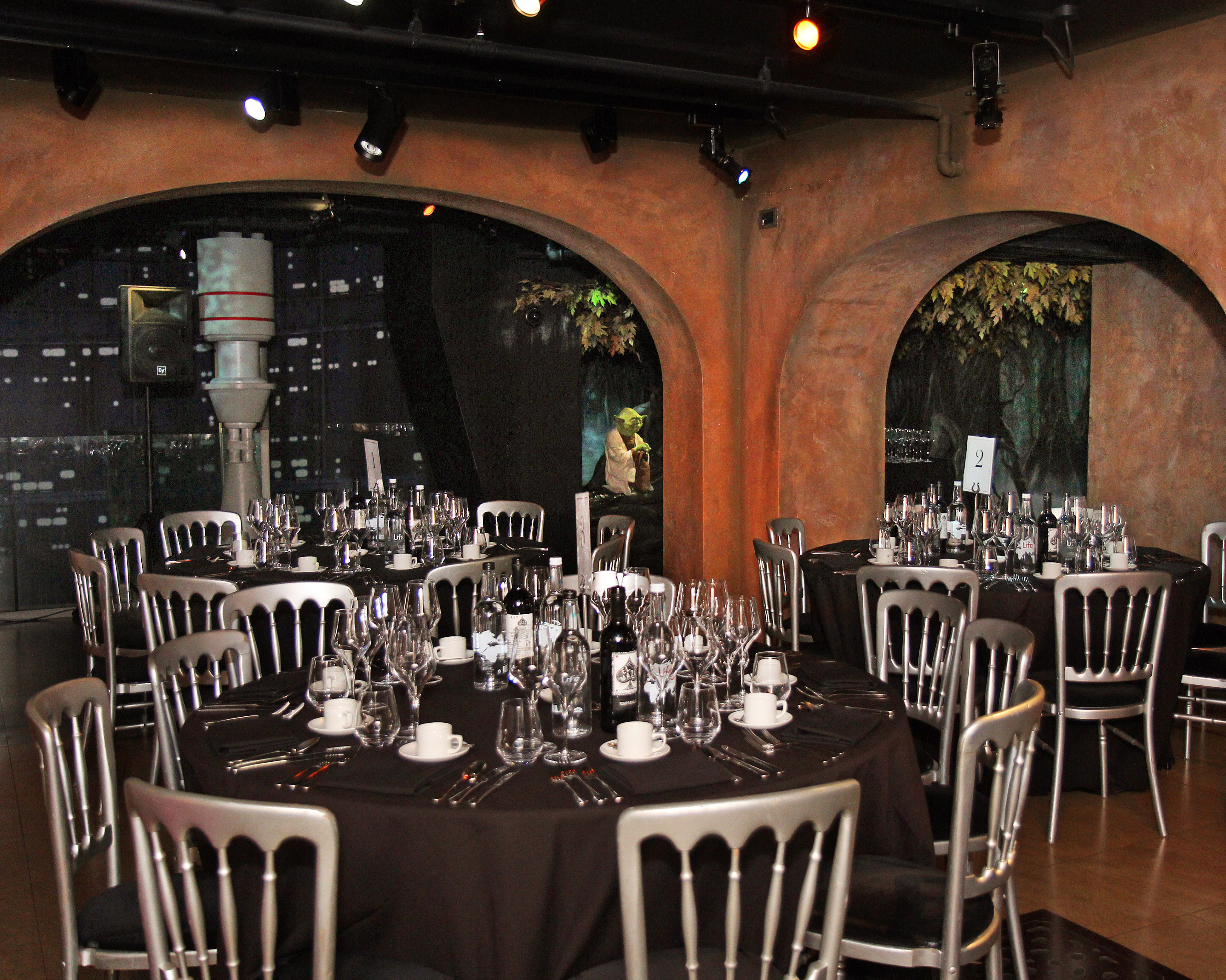 Elegant event space at Madame Tussauds with round tables for formal dinners or corporate events.