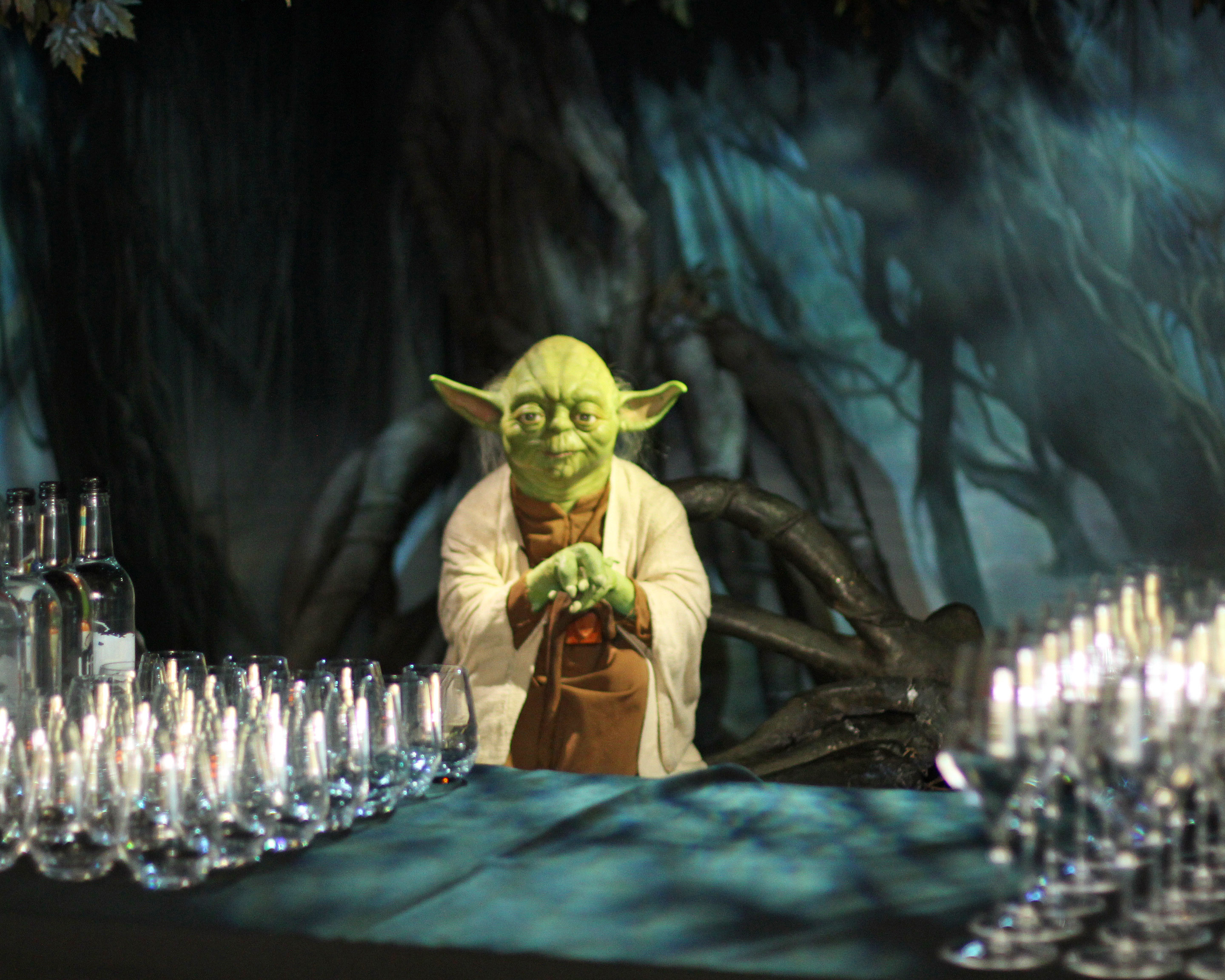 "Whimsical mentor character at themed event table in Madame Tussauds"