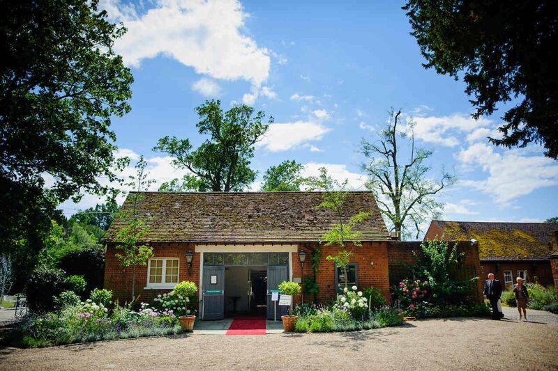 Lakeside venue with rustic charm and red carpet, ideal for outdoor events and gatherings.