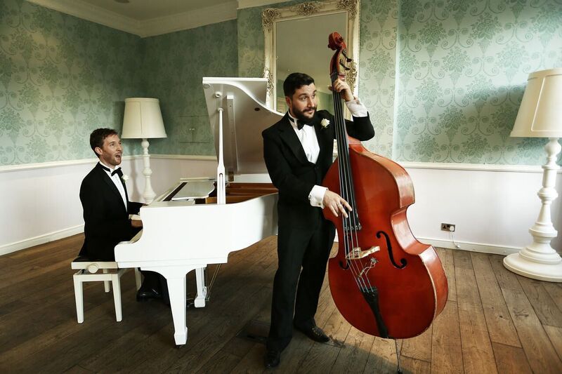 Elegant pianist and bassist duo performing at a sophisticated event in Stoke Place.