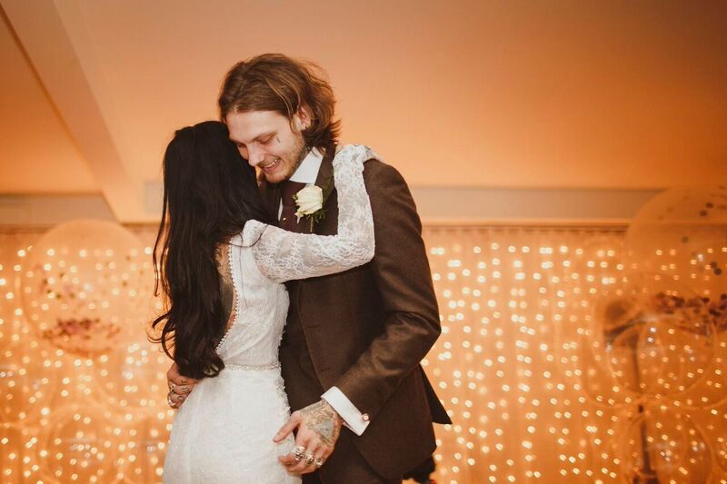 Couple's intimate wedding reception at Lakeside, Stoke Place with twinkling lights.
