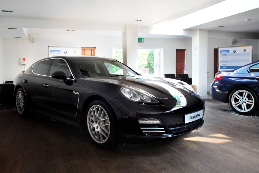 Luxury car in modern showroom, perfect for corporate events and product launches.