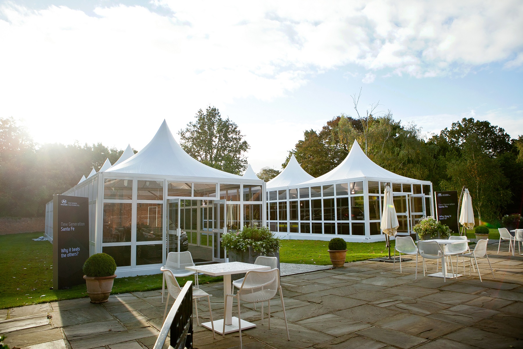 Elegant outdoor event space with white tents at Stoke Place for weddings and corporate gatherings.