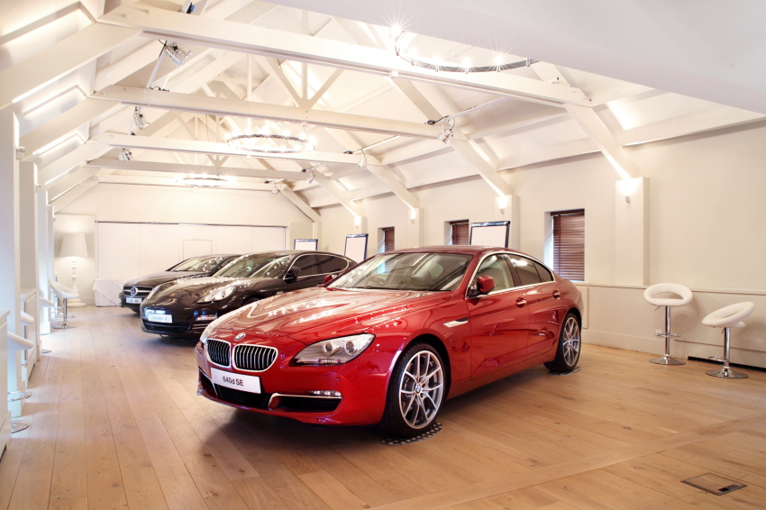 Stylish event space at Stoke Place with sleek red car for upscale automotive showcase.