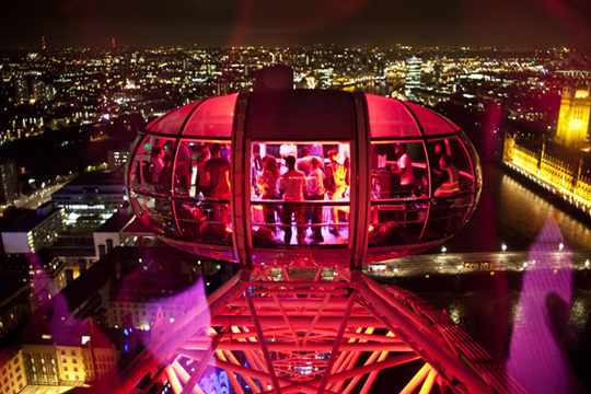 Private Capsule event in London Eye with vibrant city views and colorful lighting.