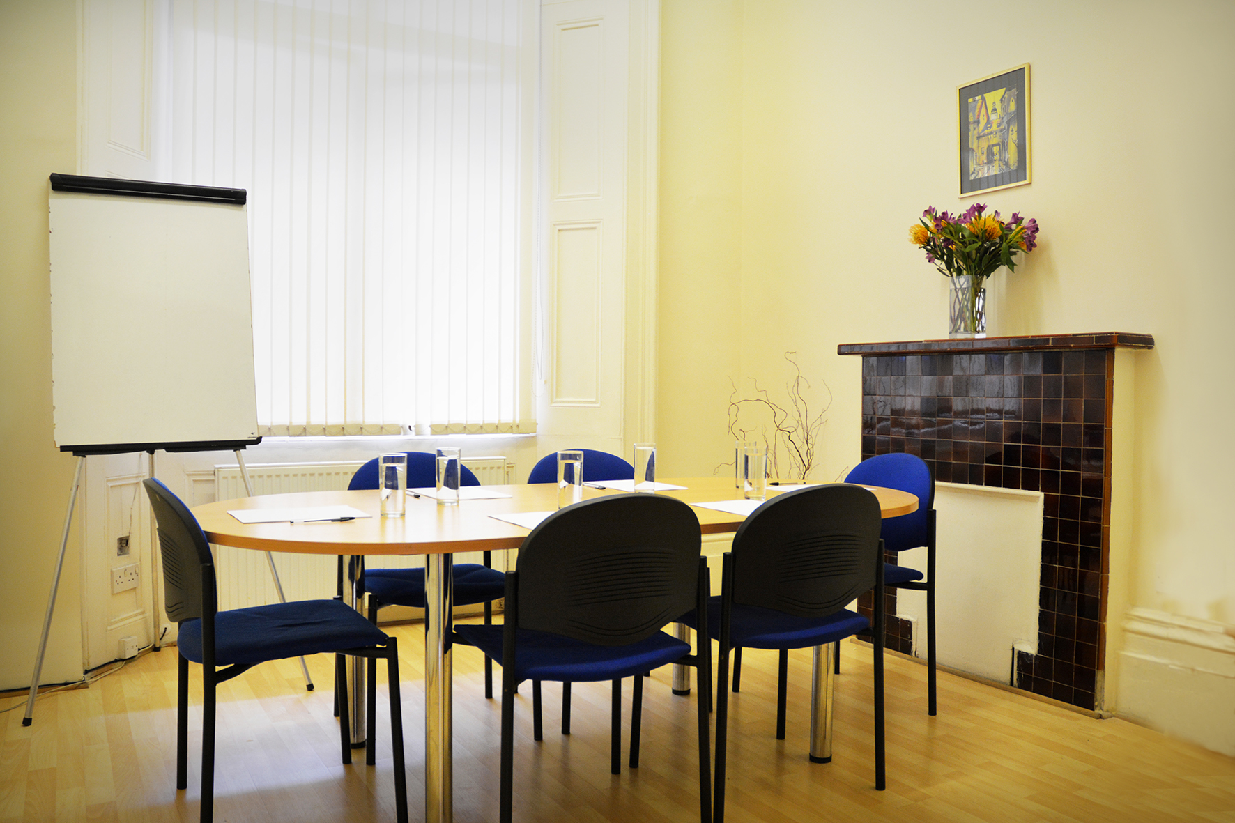 Queensborough Meeting Room with round table, ideal for small group discussions and events.