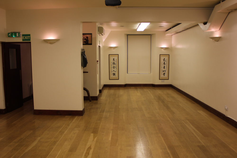 Versatile event space with wooden flooring for workshops and gatherings at Simon Lau Centre.