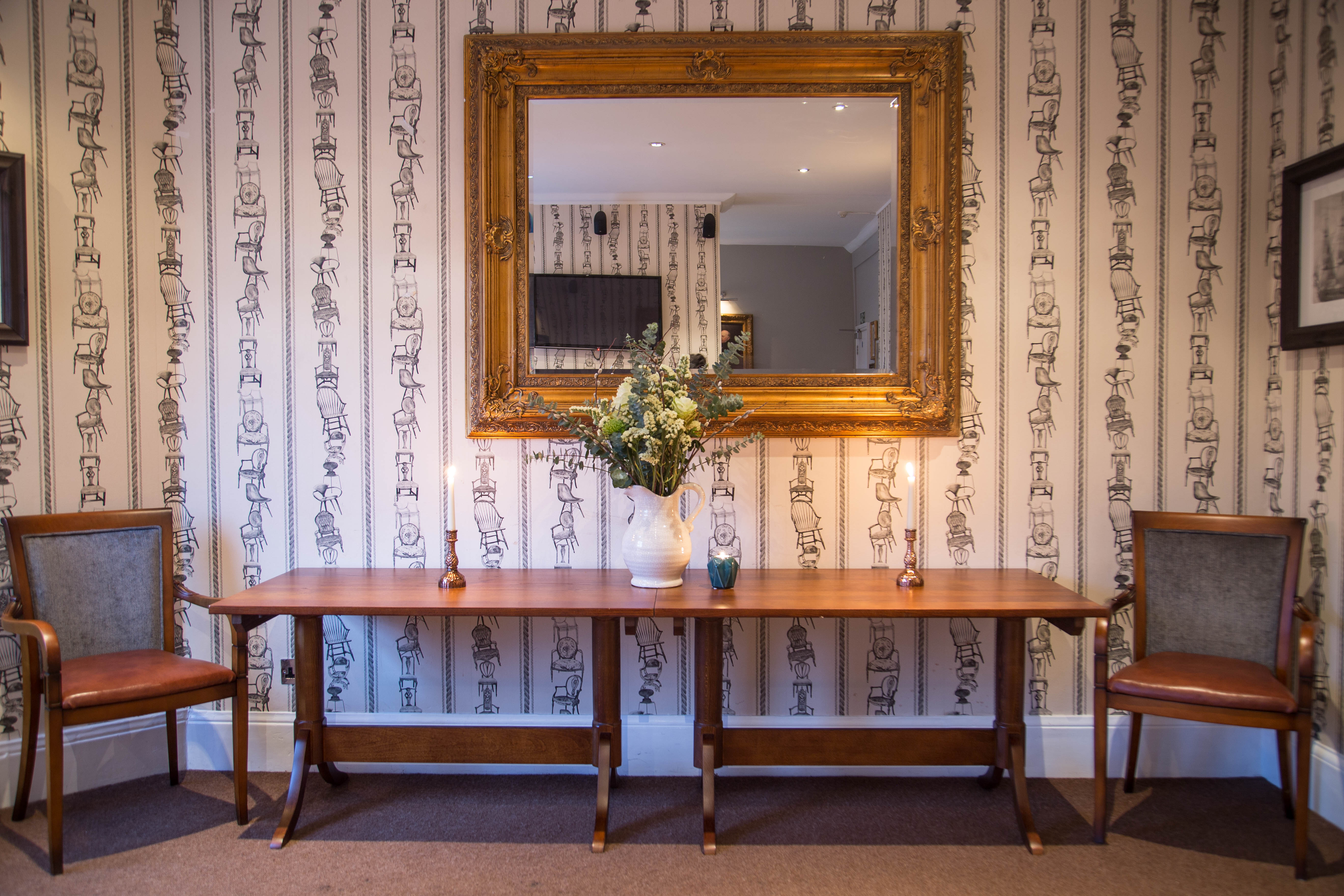 Elegant entryway of The Navarino Room for events with stylish seating and decor.