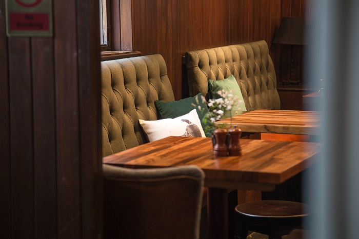 Cozy meeting space with tufted seating at The Admiral Codrington for gatherings.