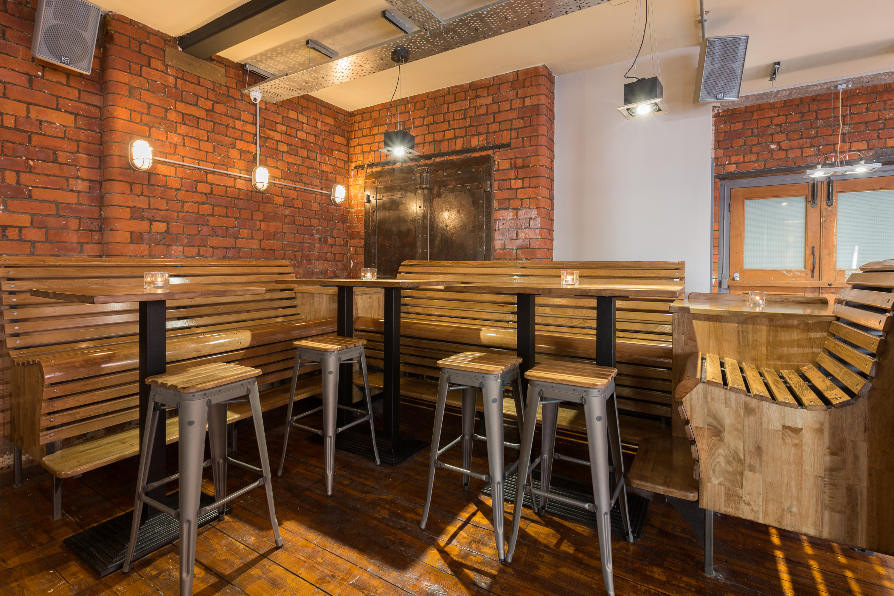 Stylish venue with exposed brick walls, ideal for intimate gatherings and meetings.