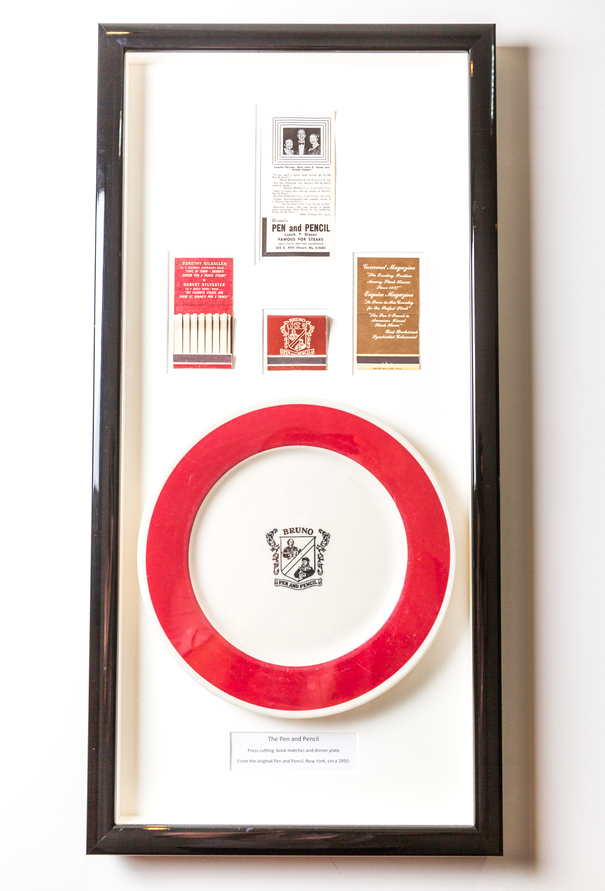 Framed memorabilia display at The Pen and Pencil venue, enhancing event storytelling.